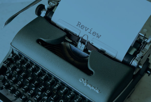 Typewriter with the word review typed on paper