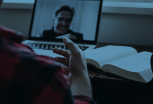 Video chat person talking to a man on a laptop.