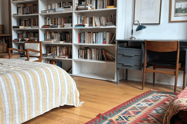 Apartment with bookshelves and desk in the bedroom.